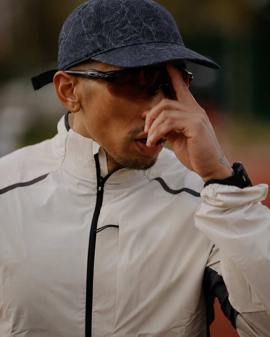 Transit — navy run cap with sport shades, track athlete